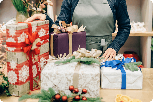 seller-with-gift-boxes-in-festive-wrapping-paper-2024-12-04-01-26-15-utc (1)